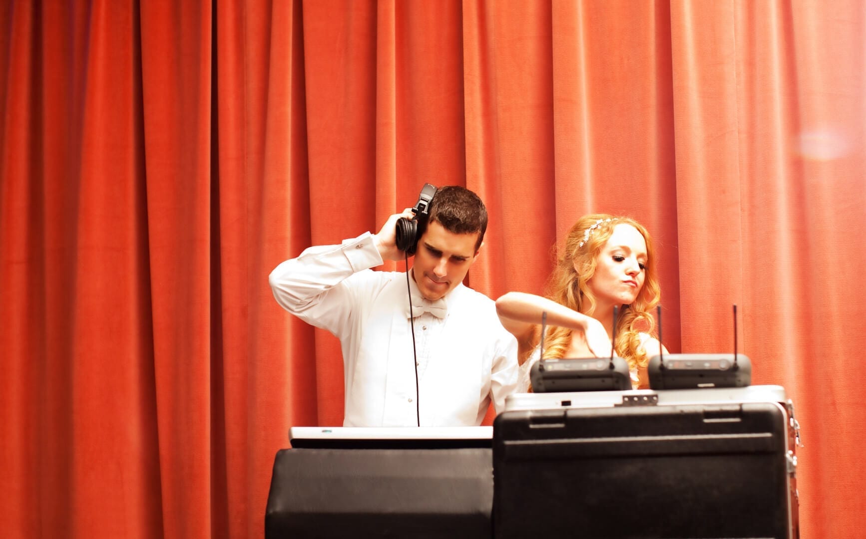 A newlywed couple enjoy DJing music on their wedding day