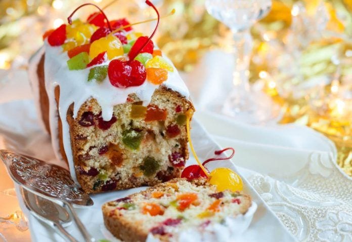 Christmas fruitcake with sugar icing and candied fruits