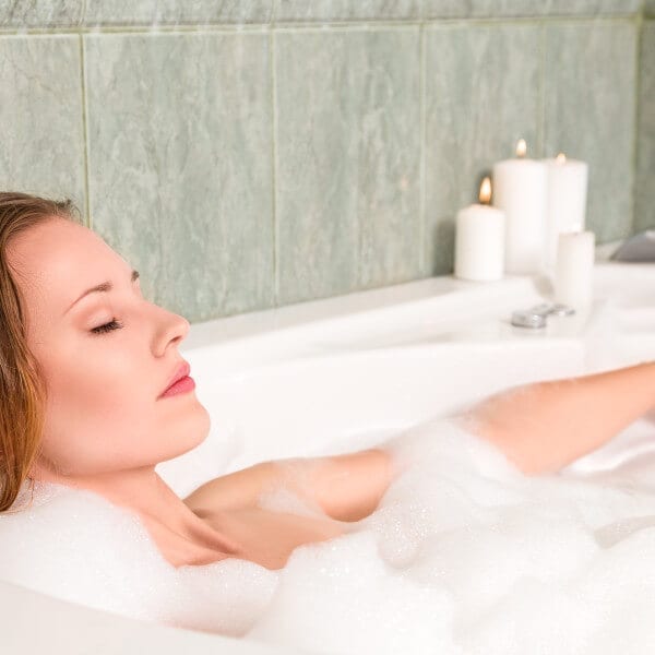 Young beautiful woman relaxing in a bath
