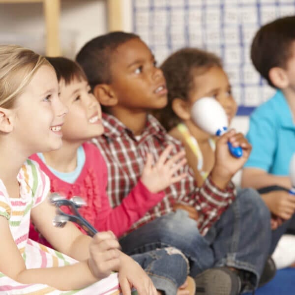 Group Of Elementary Age Schoolchildren In Music Class With Instruments