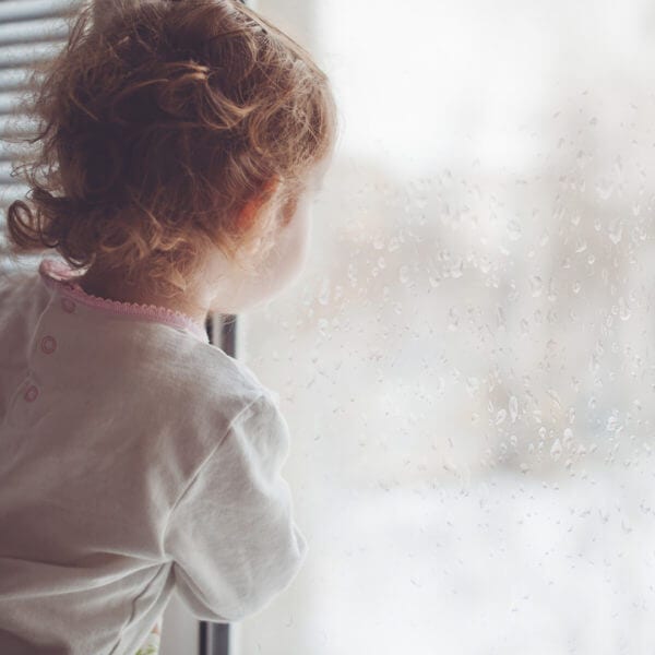 A child looks out the window.