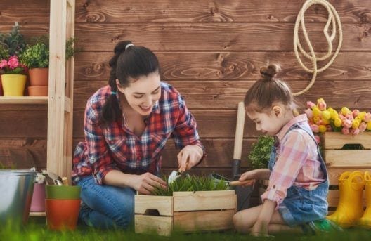 woman gardening with child