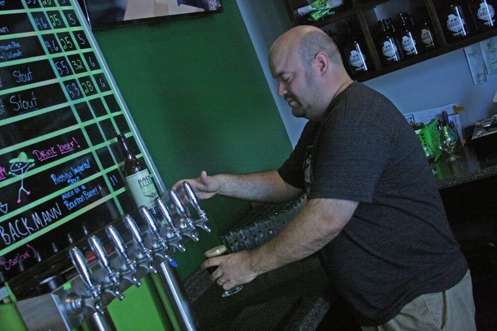Owner Pouring Beer from Tap