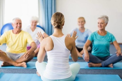 retirement age women doing yoga