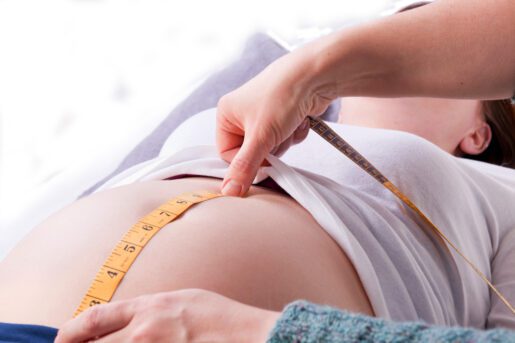 midwife measuring a pregnant mother's belly