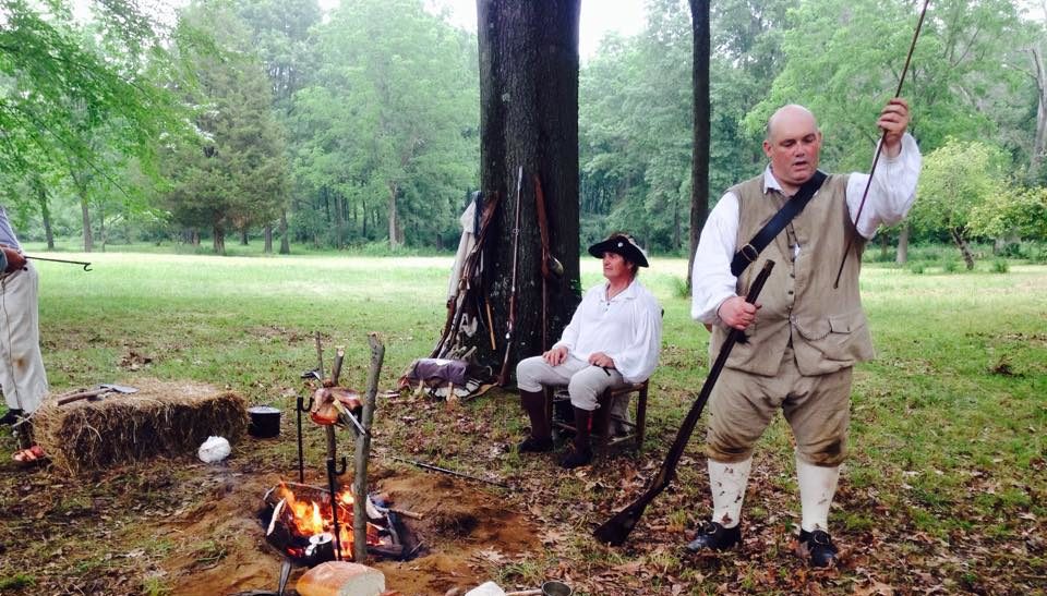 shot of reenactors with tools in a wooded area