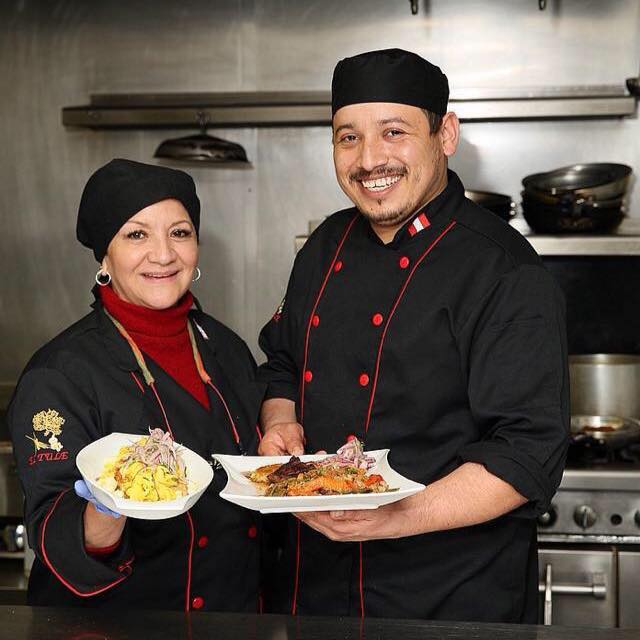Chefs pose with meal