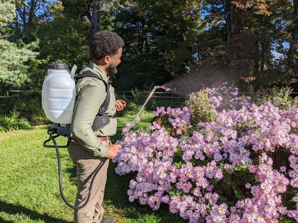 Worker Spraying Deer Repellent