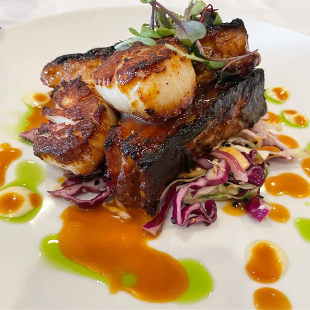 Maple glazed Berkshire pork belly and Jersey Day Boat Scallops over mango slaw