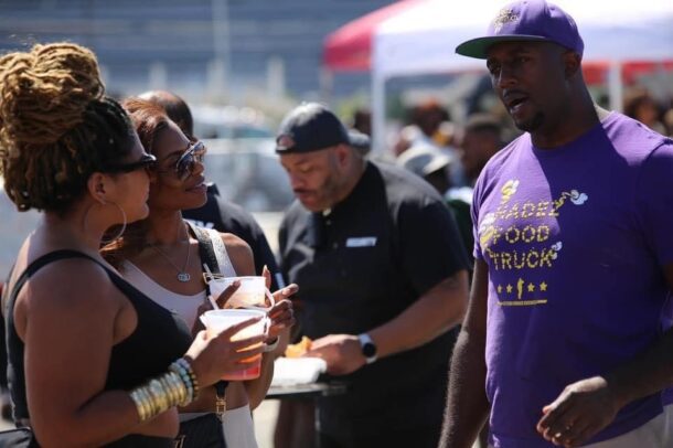 Hanif with customers