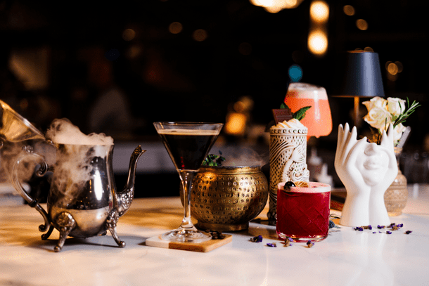 Maddy Rose at Liberty House selection of signature cocktails in tiki cups